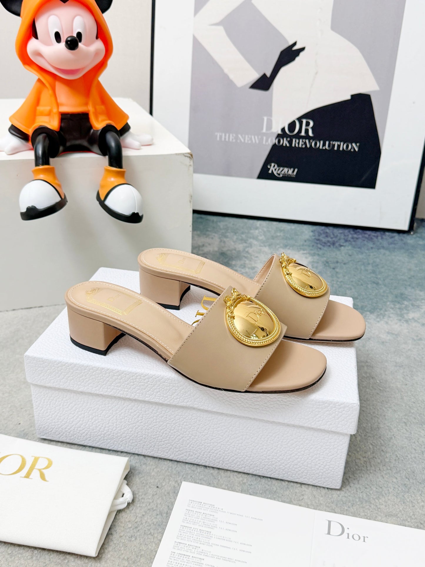 CD Heeled Mules – Alabaster Beige Smooth Lambskin Slide Sandals with Gold-Finish Crest