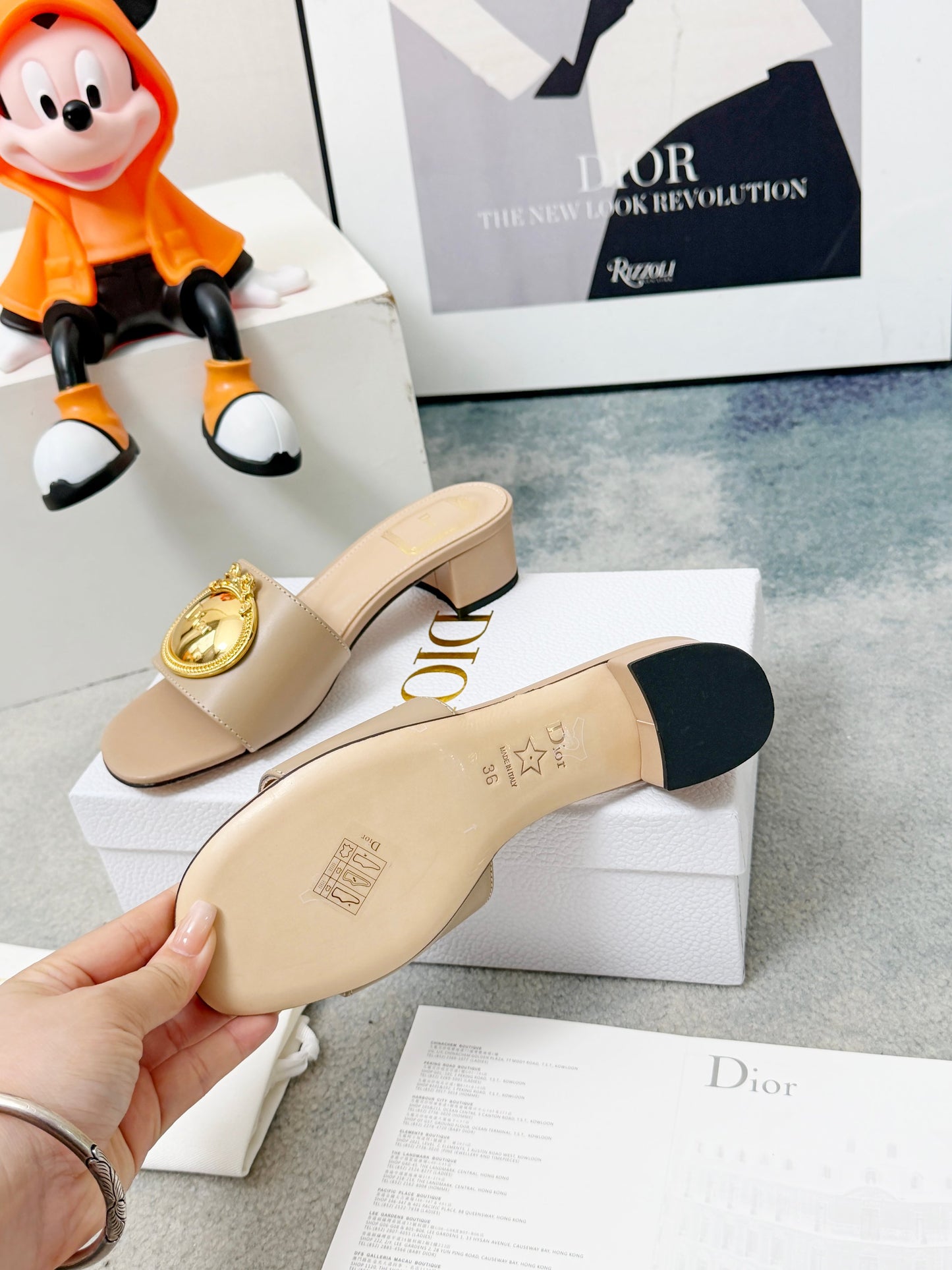 CD Heeled Mules – Alabaster Beige Smooth Lambskin Slide Sandals with Gold-Finish Crest
