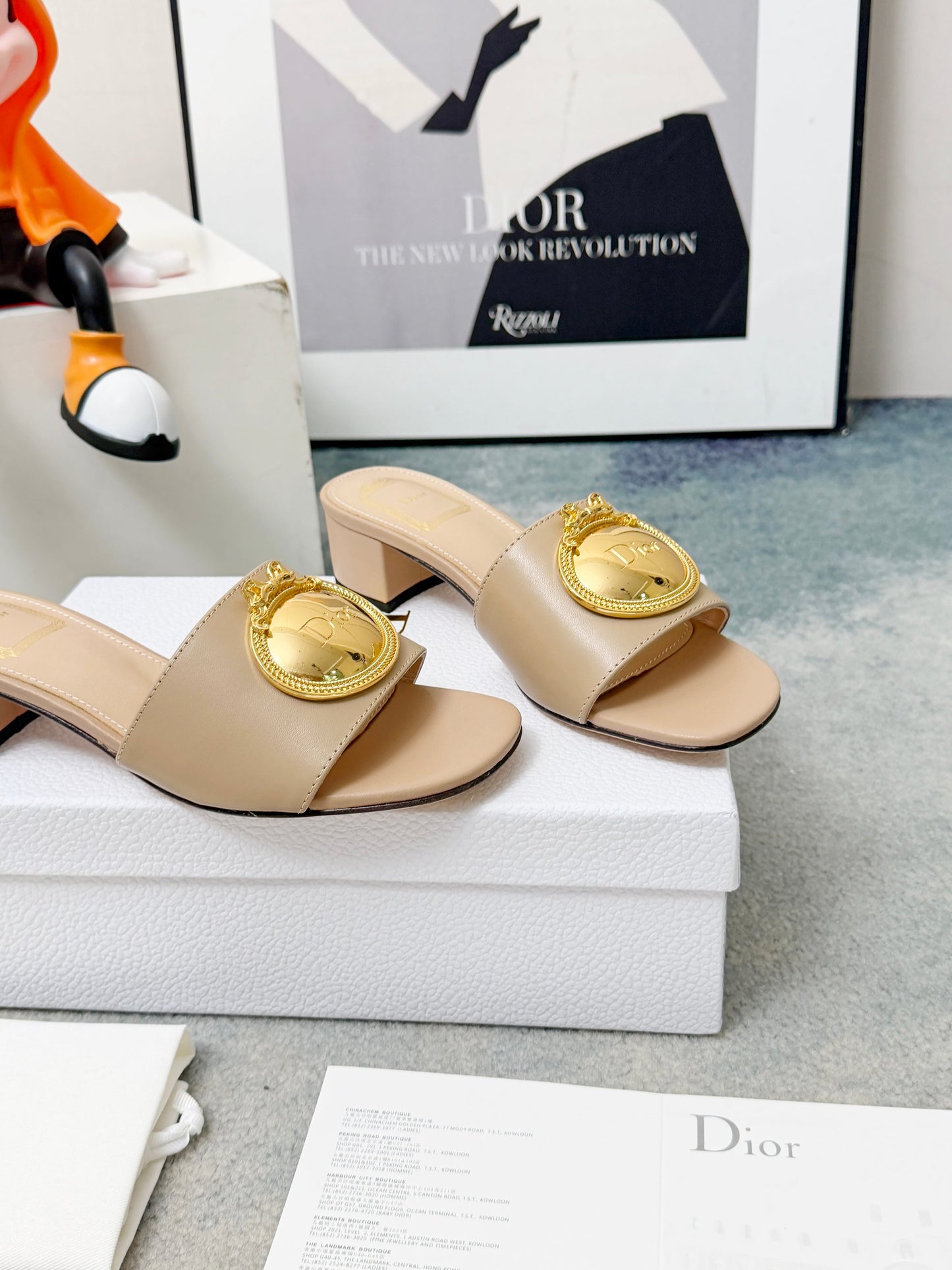 CD Heeled Mules – Alabaster Beige Smooth Lambskin Slide Sandals with Gold-Finish Crest
