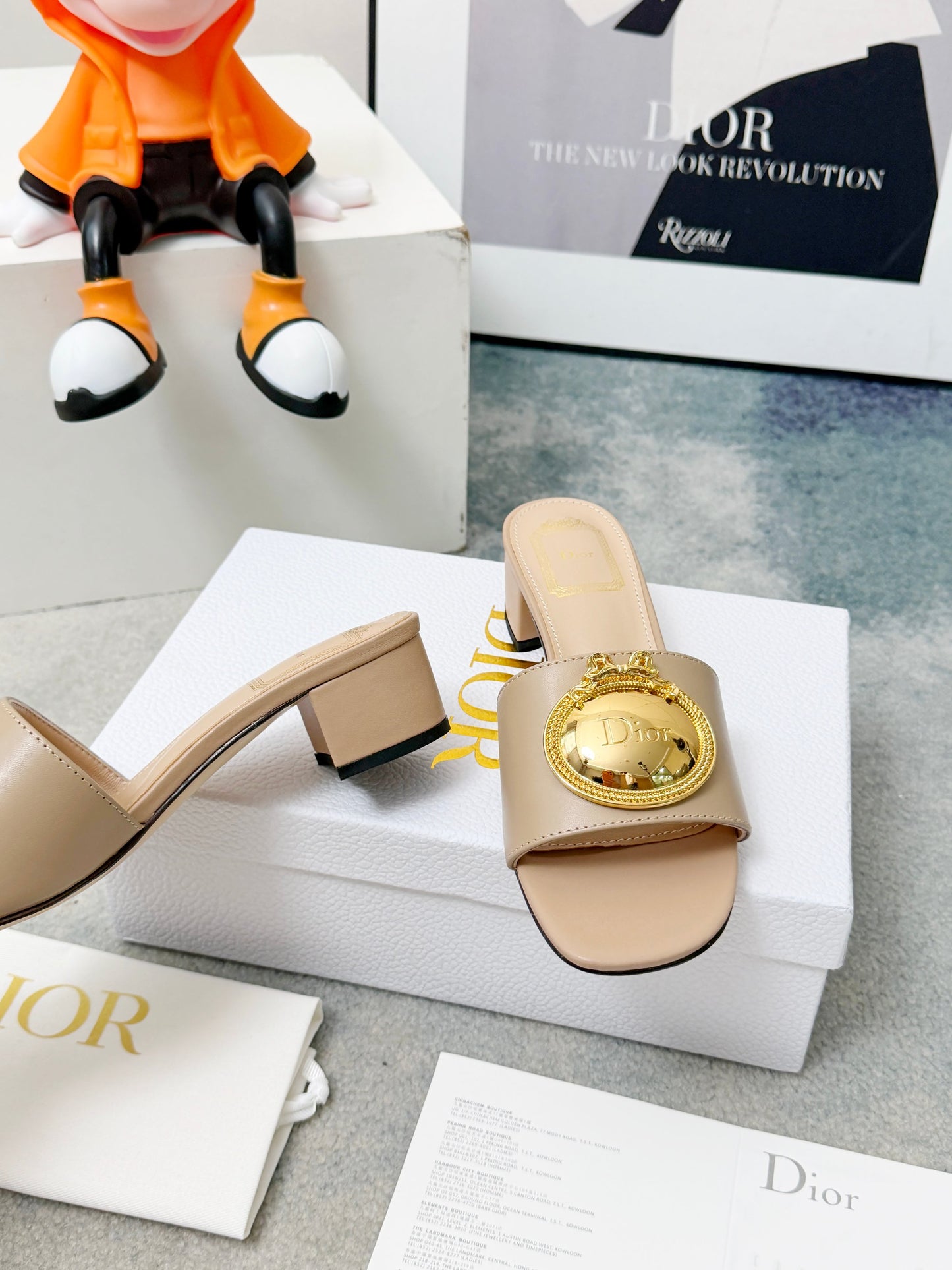 CD Heeled Mules – Alabaster Beige Smooth Lambskin Slide Sandals with Gold-Finish Crest