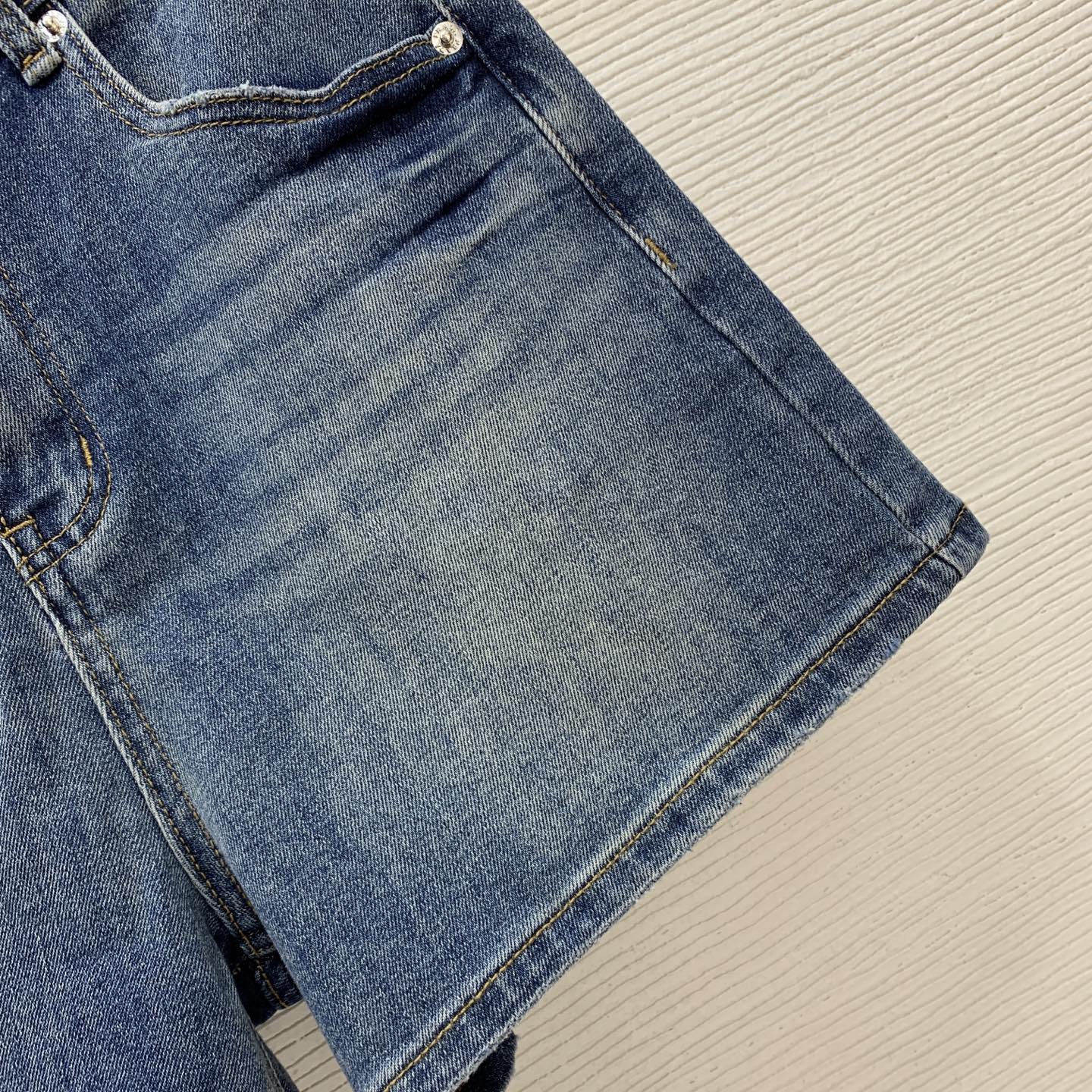 Denim Shorts – Vintage Indigo Stone-Washed Rigid Cotton Denim High-Rise Shorts with Enameled Metal Plaque