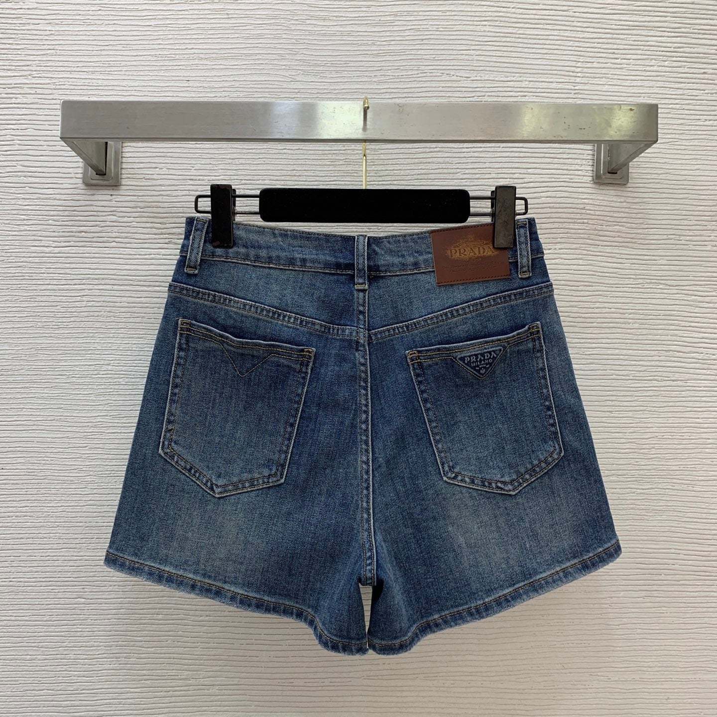 Denim Shorts – Vintage Indigo Stone-Washed Rigid Cotton Denim High-Rise Shorts with Enameled Metal Plaque