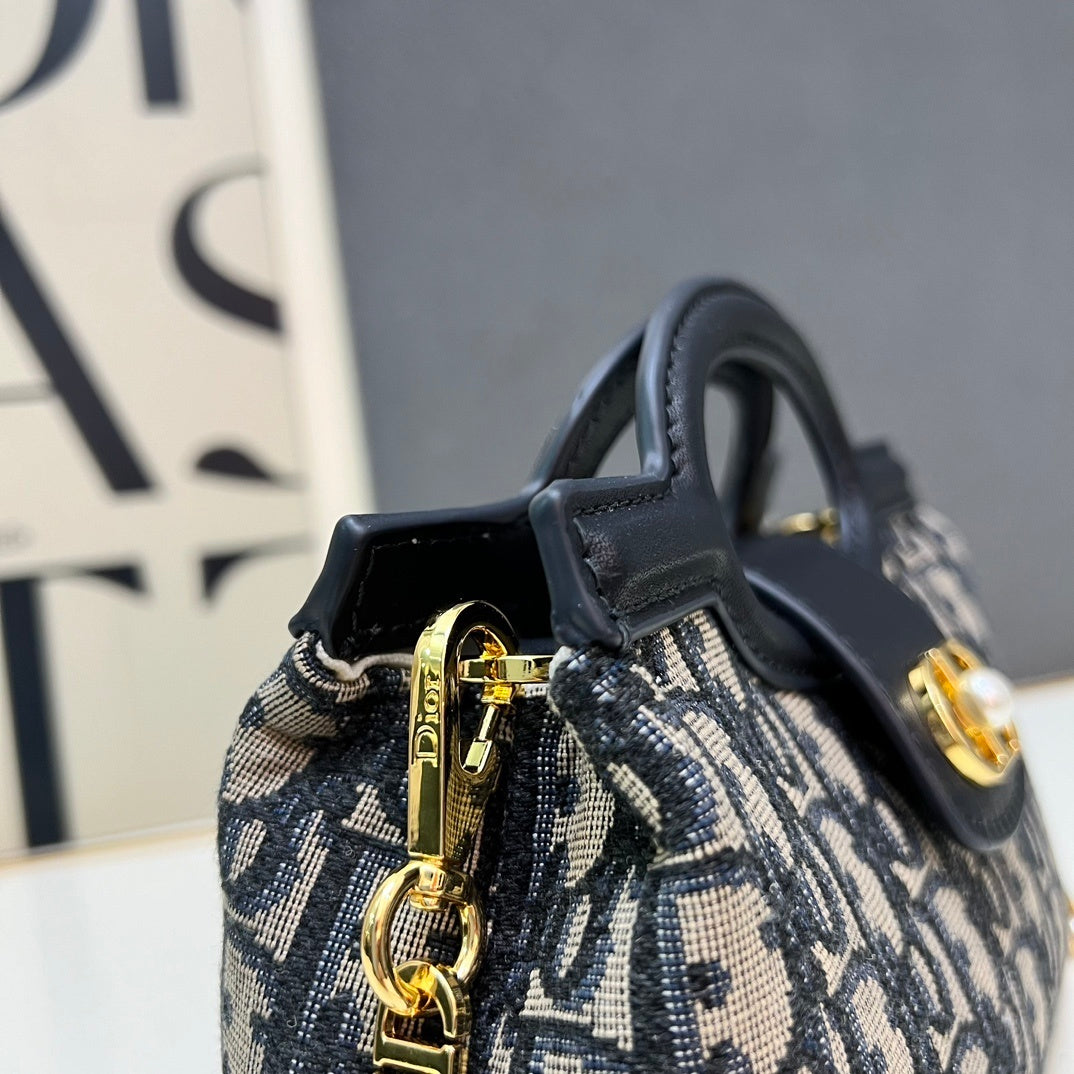 Christian Bobby East-West Bag – Blue Oblique Jacquard Canvas with Gold-Tone CD Buckle